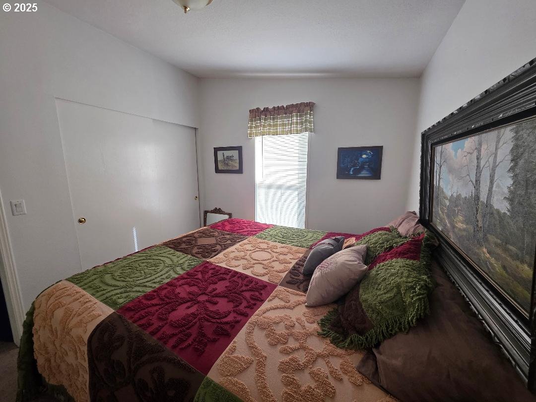 232 South Oak Road Wamic, OR 97063 - Photo 20 of 31 a bedroom with a bed and a painting on the wall