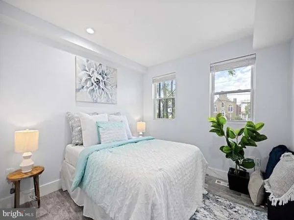 a bedroom with a bed and a potted plant