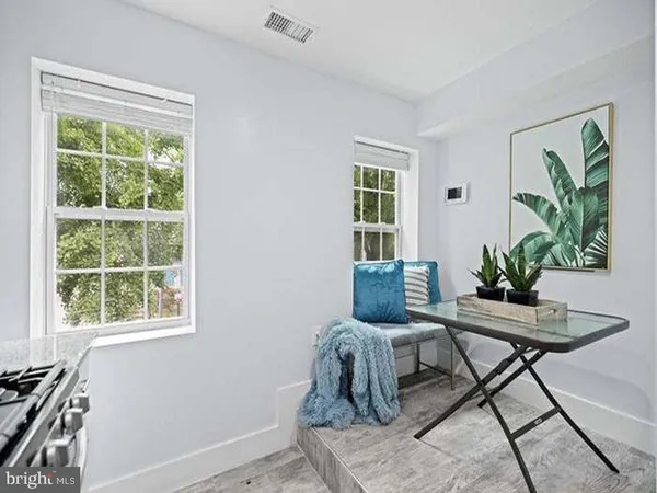 a dining room with furniture and a window