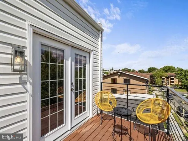 a view of a balcony with table and chairs
