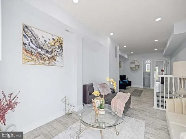 a living room with furniture a dining table and a painting