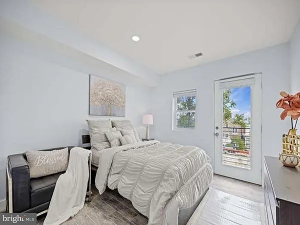 a bedroom with a large bed and a window