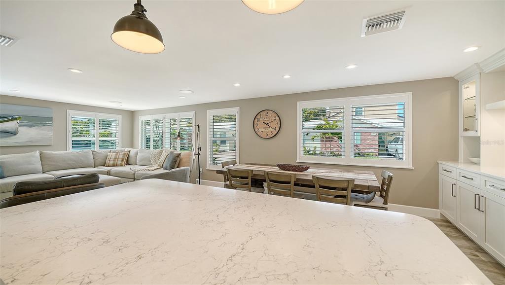 6140 Midnight Pass Road, Unit B6 Sarasota, FL 34242 - Photo 20 of 63 a spacious bedroom with a bed a couch and a window