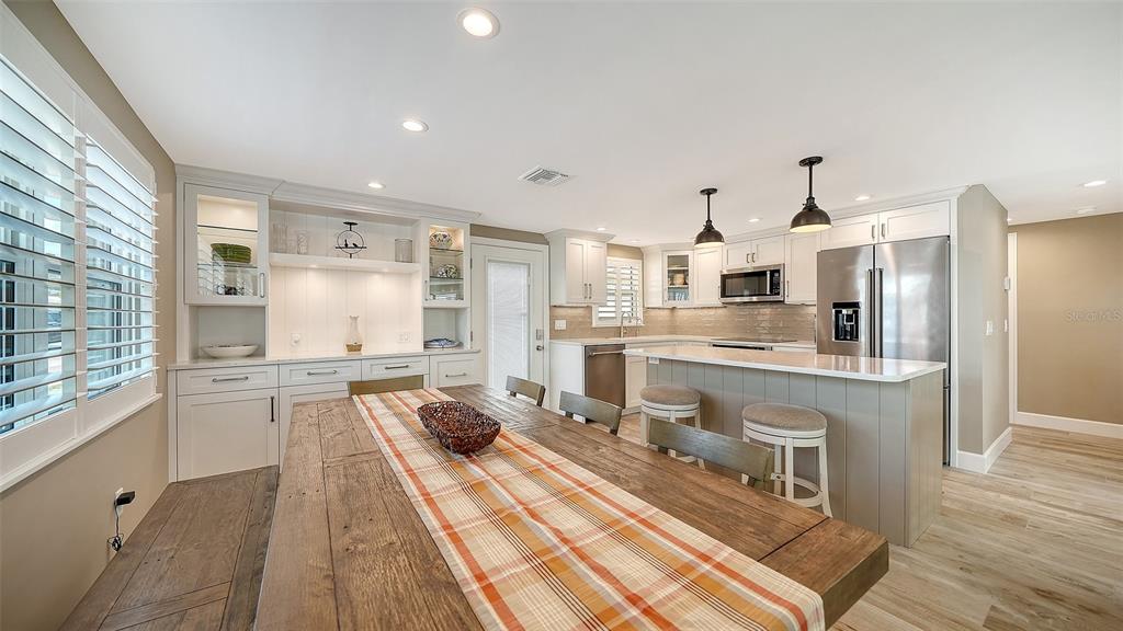 6140 Midnight Pass Road, Unit B6 Sarasota, FL 34242 - Photo 23 of 63 a large kitchen with stainless steel appliances a sink and cabinets