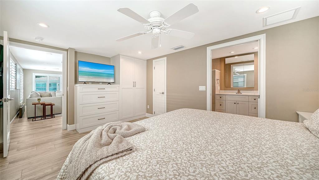 6140 Midnight Pass Road, Unit B6 Sarasota, FL 34242 - Photo 25 of 63 a bedroom with a large bed and a chandelier