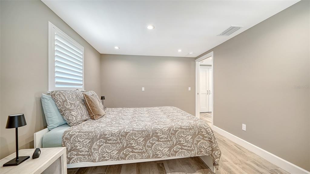 6140 Midnight Pass Road, Unit B6 Sarasota, FL 34242 - Photo 31 of 63 a large bedroom with a bed and a window
