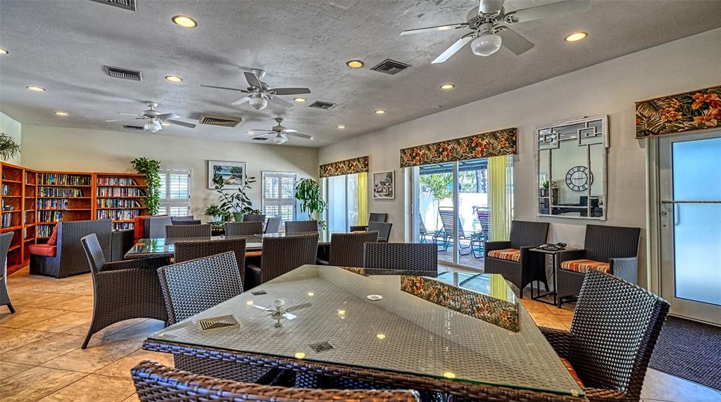 6140 Midnight Pass Road, Unit B6 Sarasota, FL 34242 - Photo 36 of 63 a living room with furniture a flat screen tv and a large window