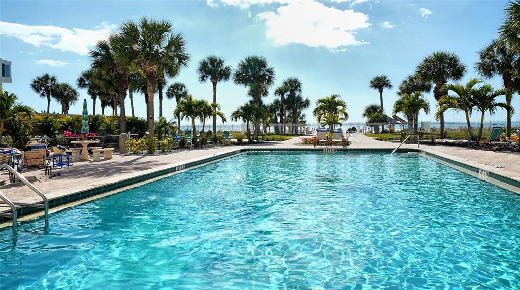 6140 Midnight Pass Road, Unit B6 Sarasota, FL 34242 - Photo 40 of 63 a view of a swimming pool and lounge chairs