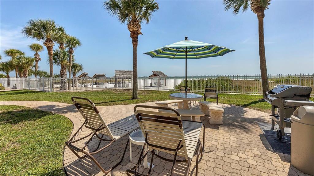 6140 Midnight Pass Road, Unit B6 Sarasota, FL 34242 - Photo 46 of 63 a view of a swimming pool and lounge chairs