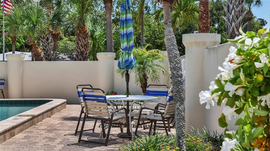 6140 Midnight Pass Road, Unit B6 Sarasota, FL 34242 - Photo 56 of 63 a view of a chairs and table in a backyard