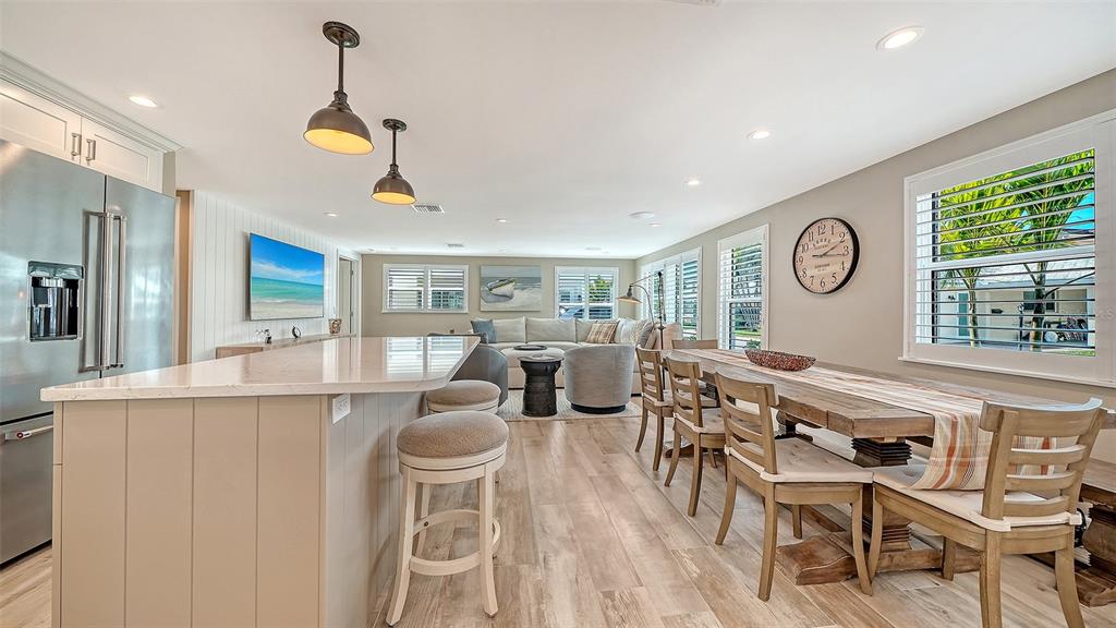 6140 Midnight Pass Road, Unit B6 Sarasota, FL 34242 - Photo 10 of 63 a very nice looking open dining room with kitchen island stainless steel appliances a table and chairs