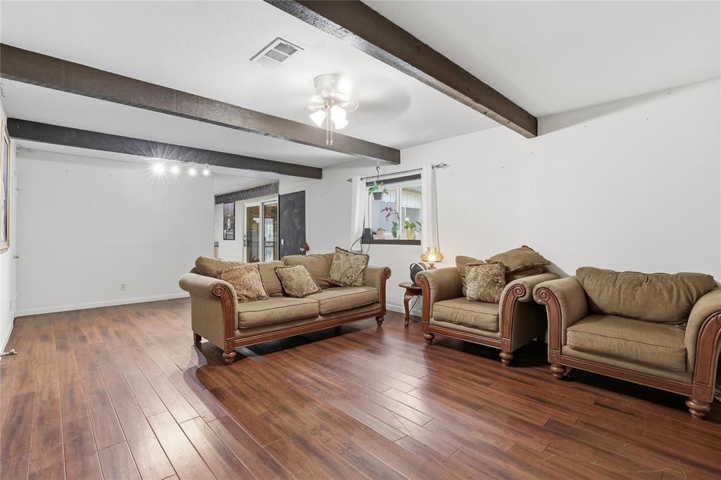 1517 Wiggins Road Maypearl, TX 76064 - Photo 22 of 31 Living room with dining space behind sofa