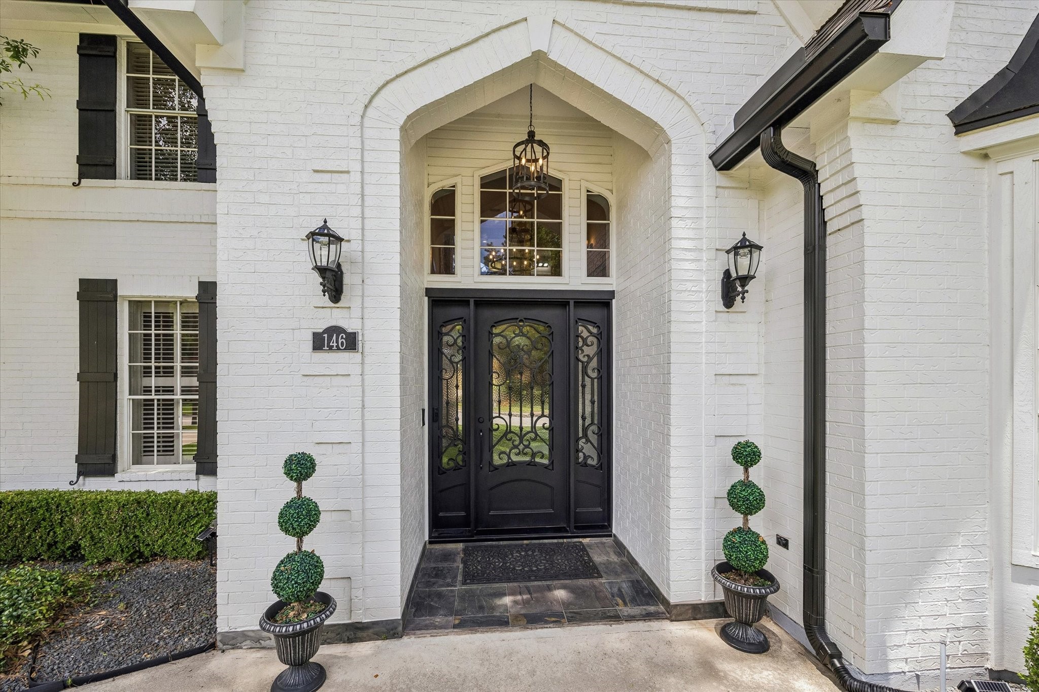 146 Golden Shadow Circle Spring, TX 77381 - Photo 4 of 41 The custom steel-and-glass door system welcomes guests in style, topped with a decorative transom that creates architectural interest.
