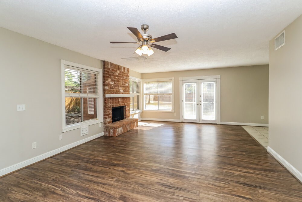 7811 Goldengrove Drive Spring, TX 77379 - Photo 4 of 17 a view of an empty room with wooden floor and a window