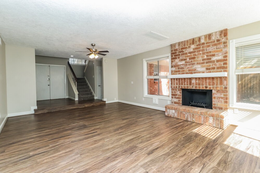 7811 Goldengrove Drive Spring, TX 77379 - Photo 5 of 17 a view of a livingroom with a fireplace and wooden floor