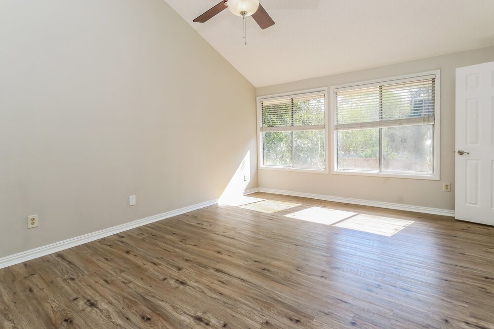 7811 Goldengrove Drive Spring, TX 77379 - Photo 10 of 17 an empty room with wooden floor and windows