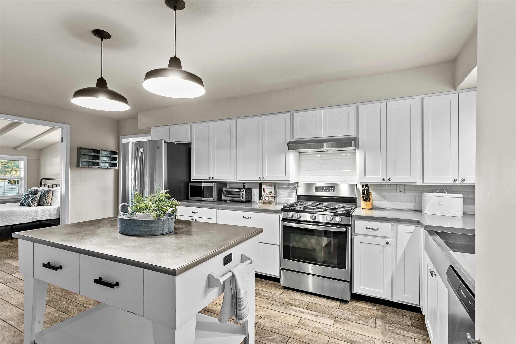 a kitchen with stainless steel appliances a sink a stove and cabinets