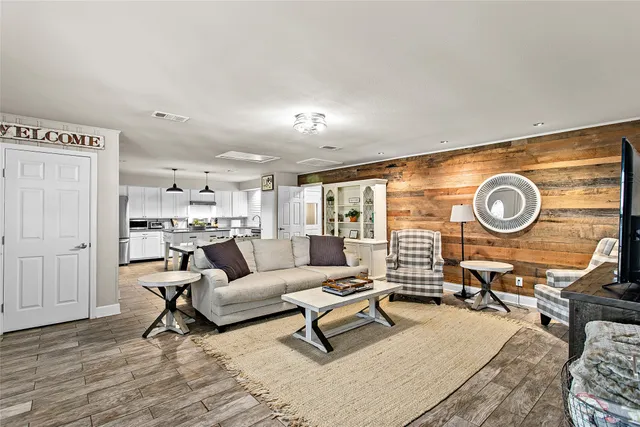 a kitchen with stainless steel appliances a dining table chairs stove and refrigerator