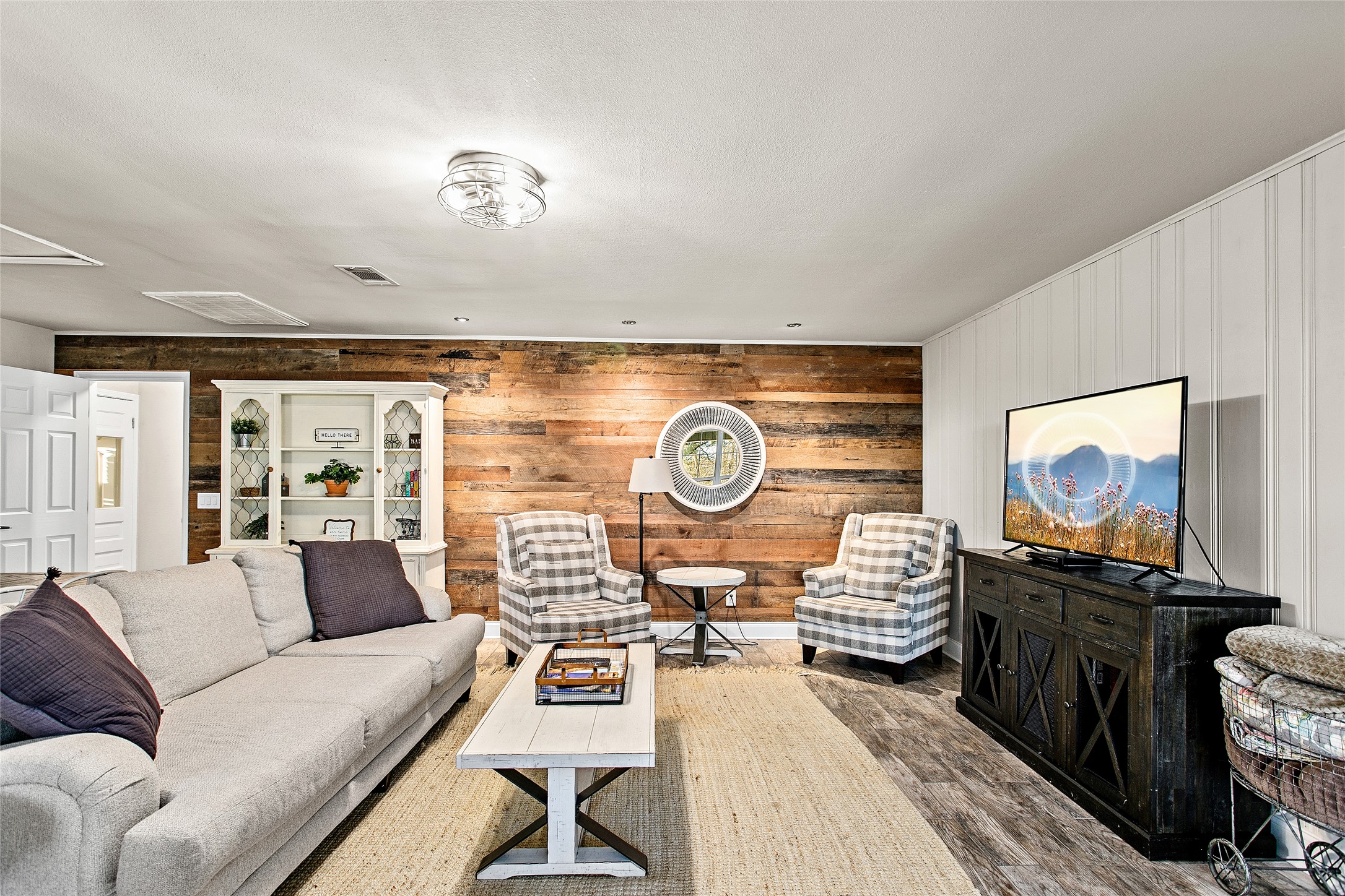 200 Creek Road Dripping Springs, TX 78620 - Photo 12 of 40 a living room with furniture a chandelier and a flat screen tv