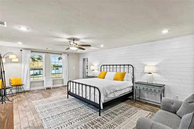 a living room with furniture a chandelier and a flat screen tv