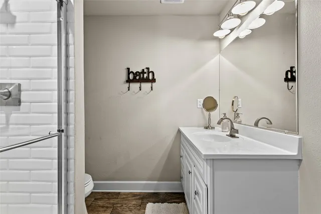 a bathroom with a toilet and a shower