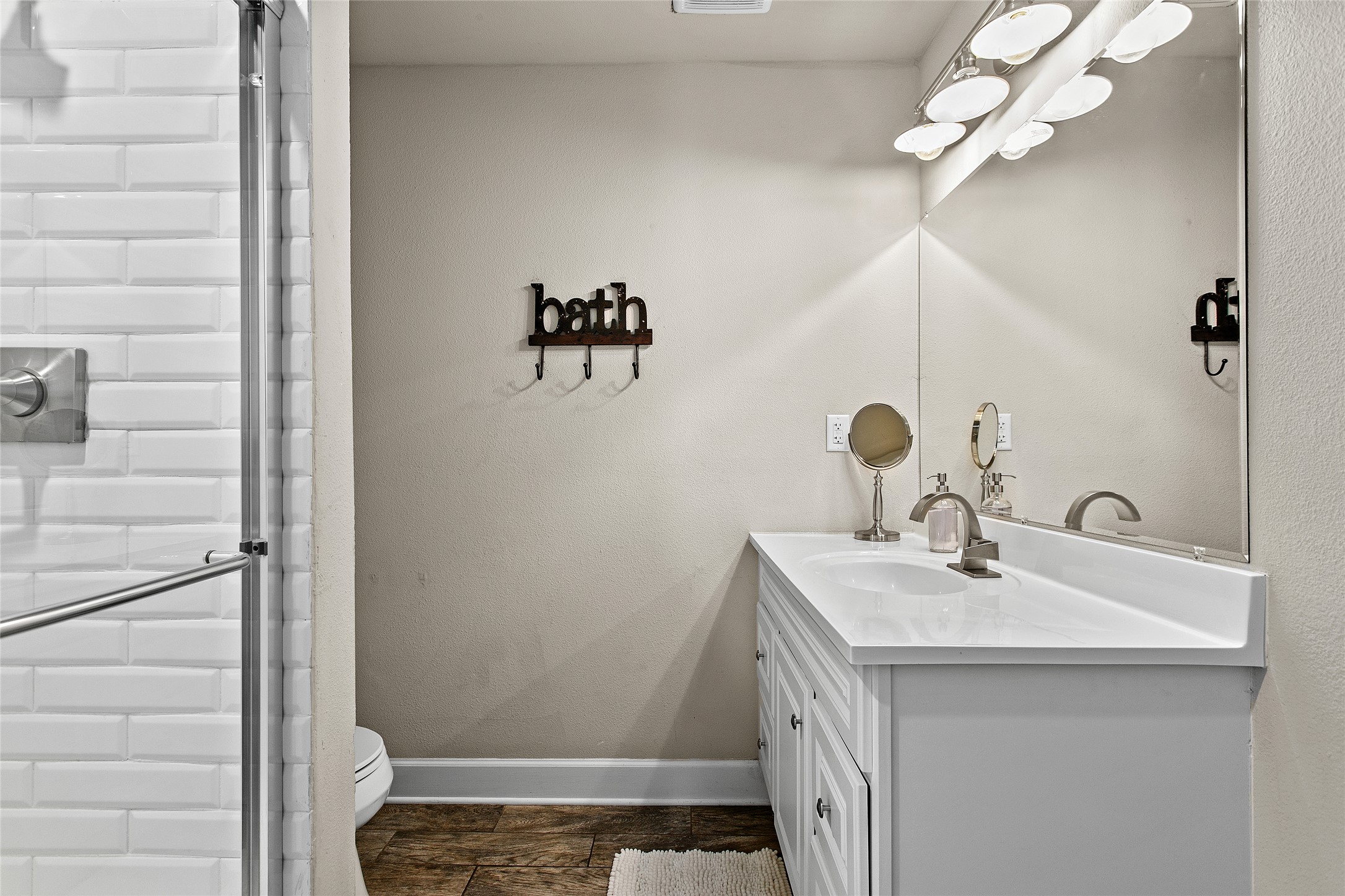 200 Creek Road Dripping Springs, TX 78620 - Photo 18 of 40 a bathroom with a sink a vanity and a mirror