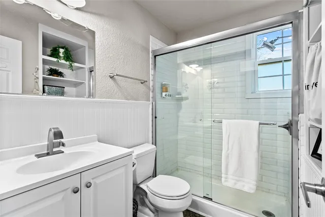 a bedroom with a bed dresser and a window