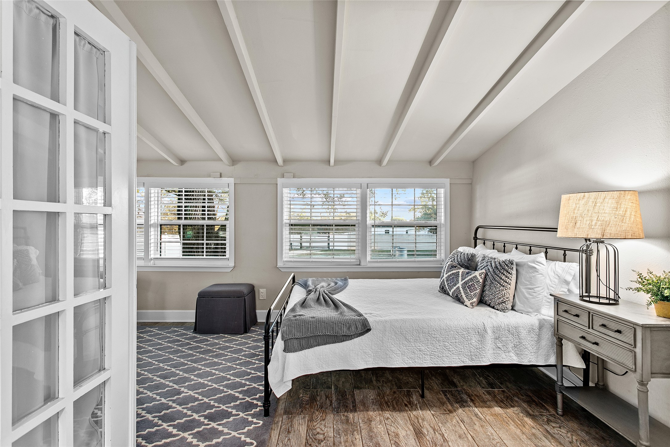 200 Creek Road Dripping Springs, TX 78620 - Photo 22 of 40 a bedroom with furniture and a window