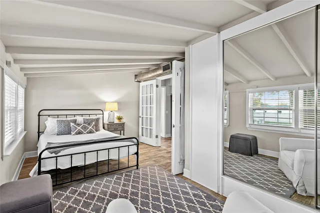 a spacious bedroom with a bed and a couch