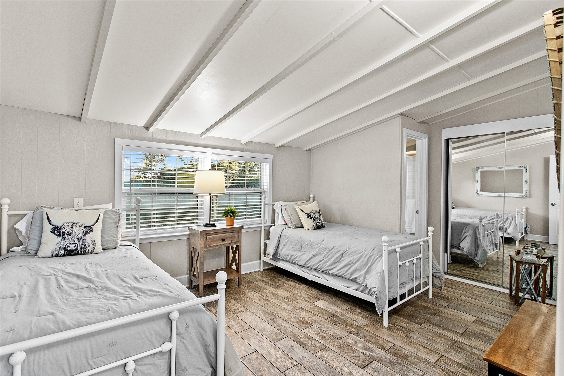200 Creek Road Dripping Springs, TX 78620 - Photo 25 of 40 a bedroom with a bed and wooden floor
