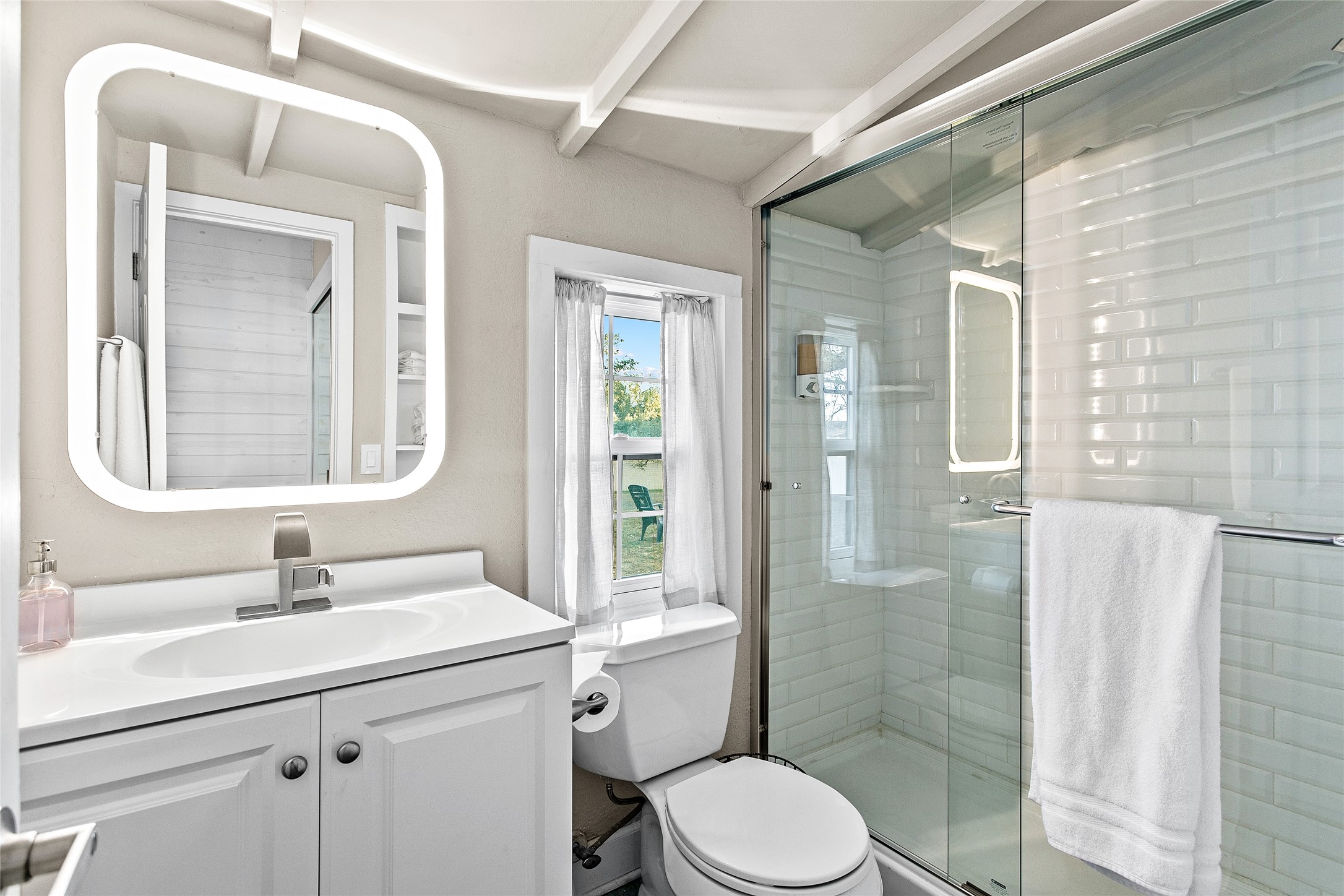 200 Creek Road Dripping Springs, TX 78620 - Photo 26 of 40 a bathroom with a sink a toilet and shower