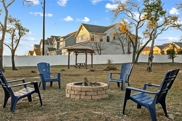 a roof deck with table and chairs under an umbrella