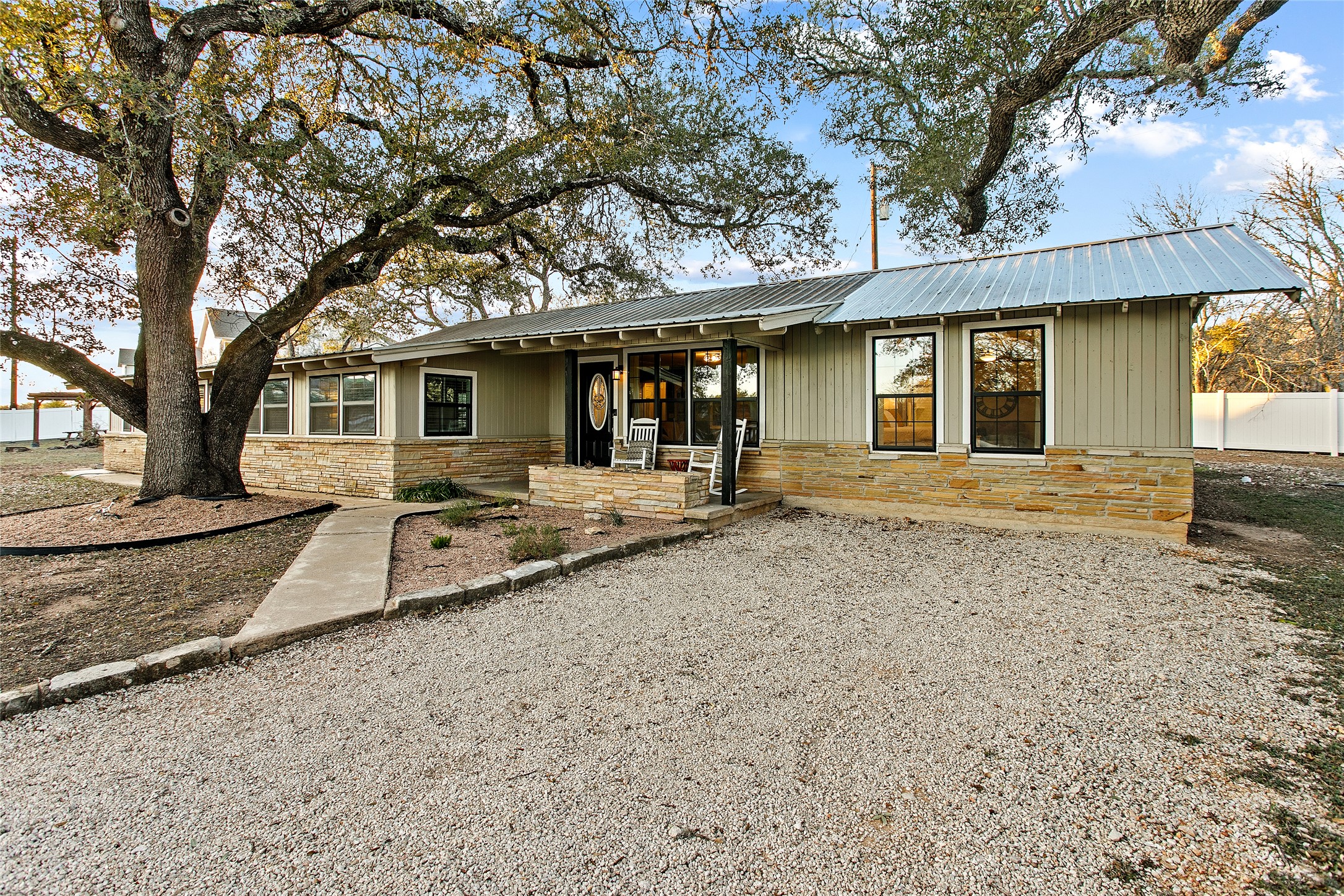 200 Creek Road Dripping Springs, TX 78620 - Photo 35 of 40 a front view of a house with a yard and garage