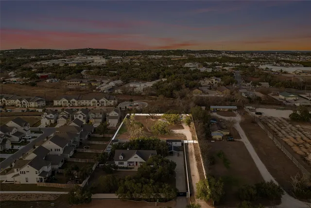 a view of a patio with table and chairs with wooden floor and fence