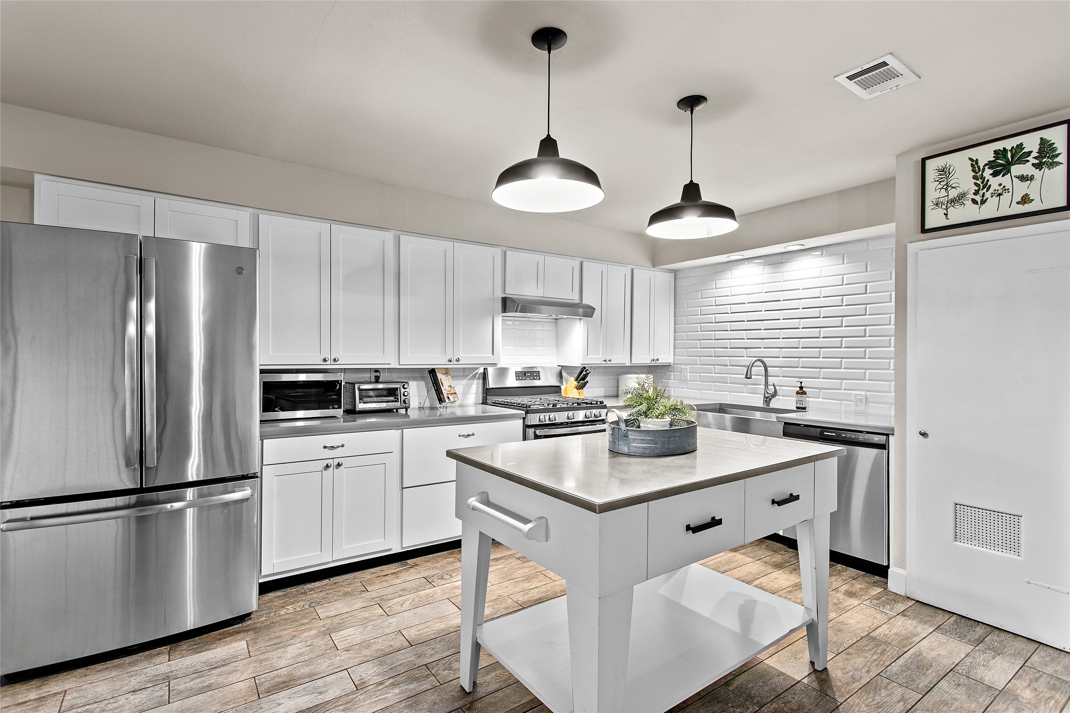 200 Creek Road Dripping Springs, TX 78620 - Photo 7 of 40 a kitchen with a center island appliances cabinets and a counter top space