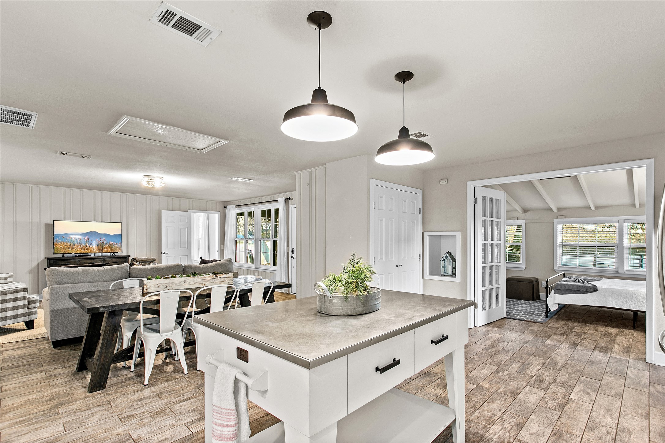 200 Creek Road Dripping Springs, TX 78620 - Photo 40 of 40 a kitchen with stainless steel appliances granite countertop a stove top oven a sink a dining table and chairs with wooden floor