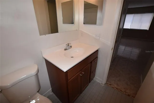 a bathroom with a sink a toilet and mirror