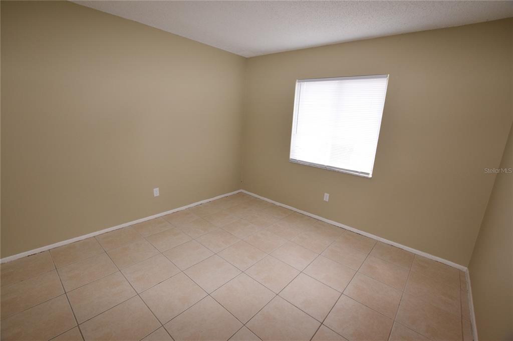 3173 Split Willow Drive Orlando, FL 32808 - Photo 13 of 16 an empty room with a window