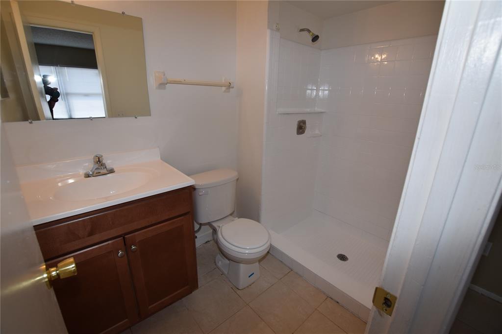 3173 Split Willow Drive Orlando, FL 32808 - Photo 14 of 16 a bathroom with a sink a toilet and shower