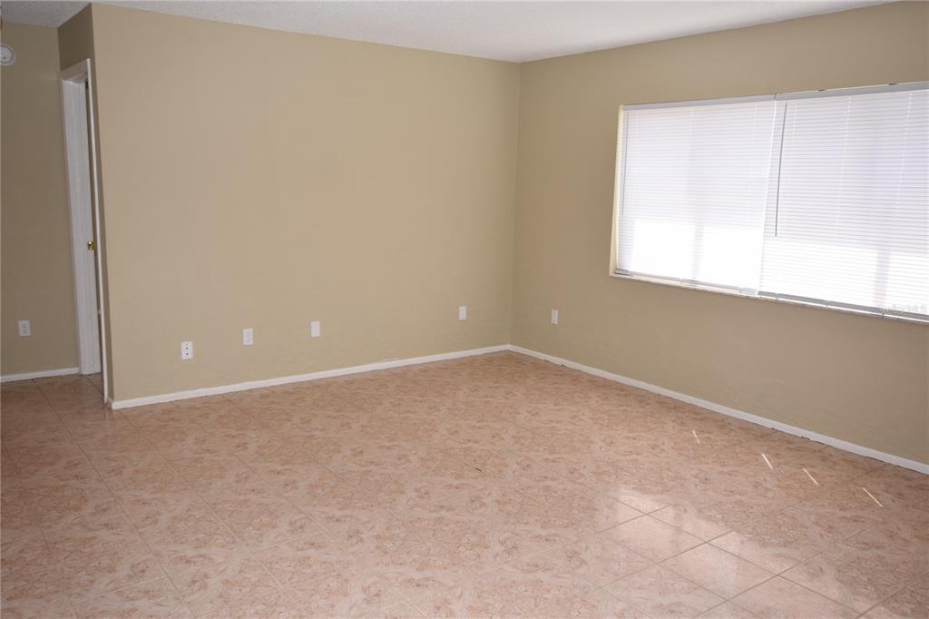 3173 Split Willow Drive Orlando, FL 32808 - Photo 4 of 16 an empty room with a window