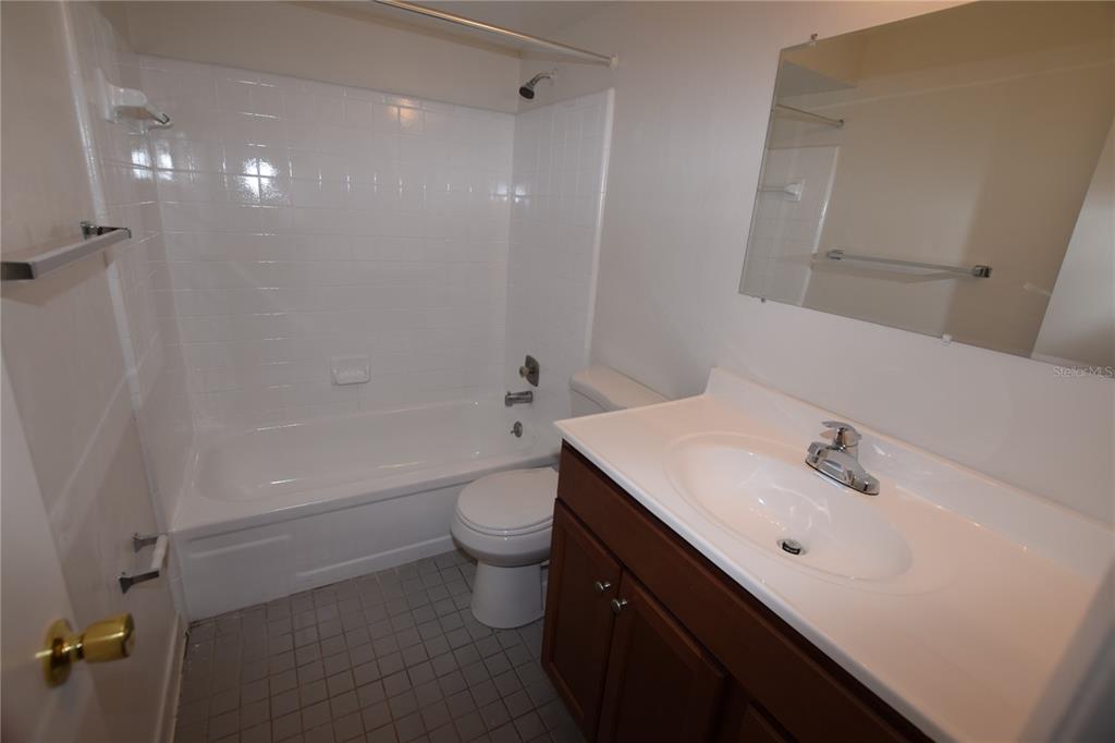3173 Split Willow Drive Orlando, FL 32808 - Photo 10 of 16 a bathroom with a sink a toilet and shower