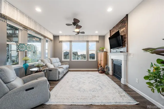 a living room with furniture a fireplace and a flat screen tv