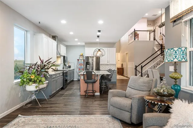 a living room with furniture potted plant and a rug