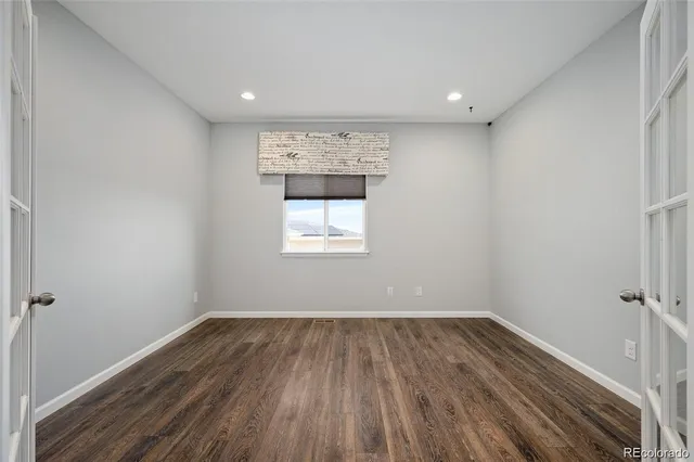 a view of room with wooden floor and fan
