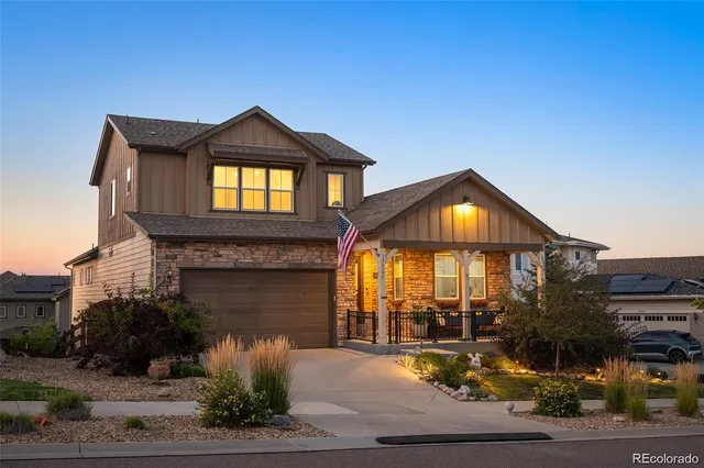 a view of a house with a yard and potted plants