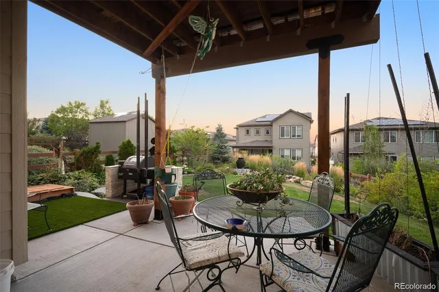 a view of a patio with table and chairs and potted plants