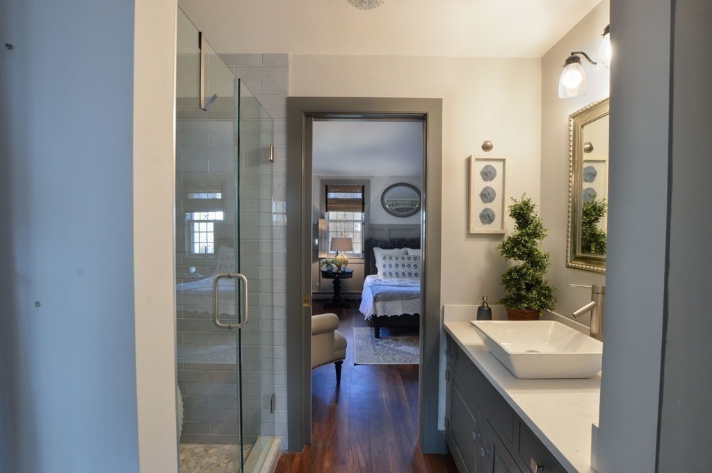 3 Academy Road Sandwich, MA 02563 - Photo 19 of 41 a en suite bathroom with a sink a mirror a bathtub and shower