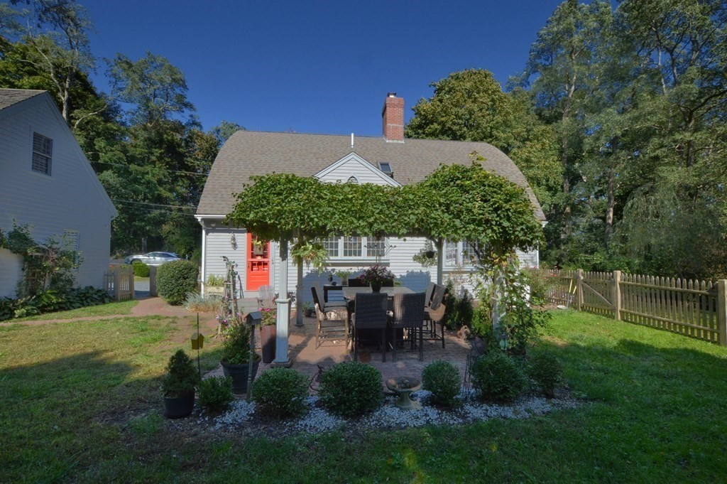 3 Academy Road Sandwich, MA 02563 - Photo 4 of 41 a view of a patio with table and chairs potted plants and large tree