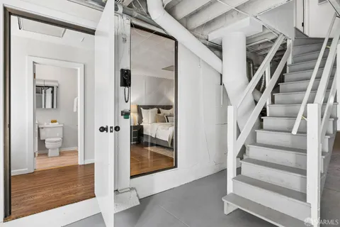 a bedroom with a bed and a potted plant