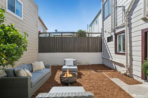 a view of a patio with swimming pool and furniture